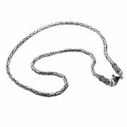 A 3mm sterling silver Byzantine necklace with ornate end caps and a lobster clasp, coiled on a clean white background.