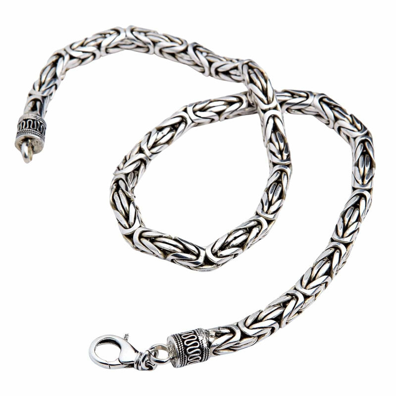 A heavy 8mm sterling silver Byzantine necklace with ornate end caps and a lobster clasp.