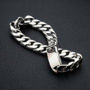 Close up of solid 925 sterling silver Cuban curb link bracelet showing polished finish and clasp