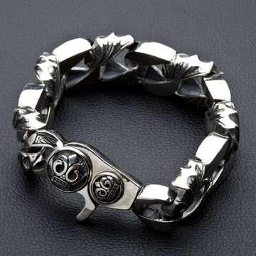 Handcrafted 925 sterling silver curb chain bracelet with tribal patterns displayed coiled