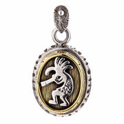 Sterling silver and brass Kokopelli pendant featuring a hand-carved Native American deity playing a flute.