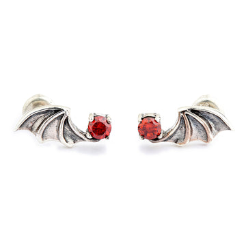 Pair of .925 sterling silver bat wing stud earrings, each set with a round red cubic zirconia