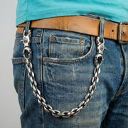 Silver biker jean chain featuring skull hooks worn on belt loops for a rocker style look.