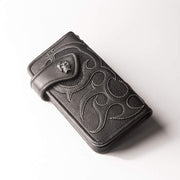 Black stingray leather long wallet with silver skull concho and flame design front angle view