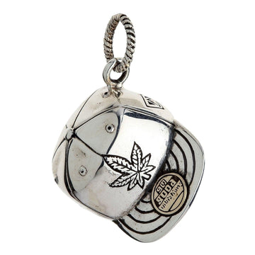 Angled view of the 925 silver cannabis leaf baseball cap pendant with a "Good Vibrations" brass accent.