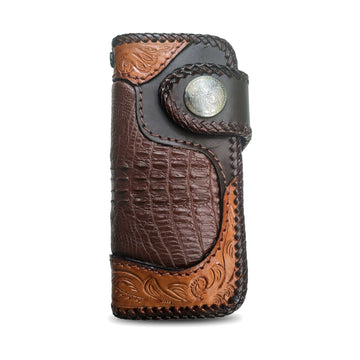 Genuine crocodile tail biker wallet, front view with tan floral-stamped corners, laced edges and a concho snap strap