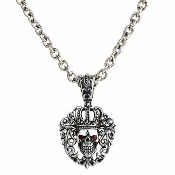 Front view of the sterling silver crowned skull pendant featuring red CZ eyes framed by gothic scrollwork.