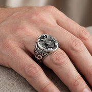 Silver double-headed eagle Masonic signet ring with ornate scrollwork design worn on a man's finger, featuring detailed heraldic eagle emblem on oval face