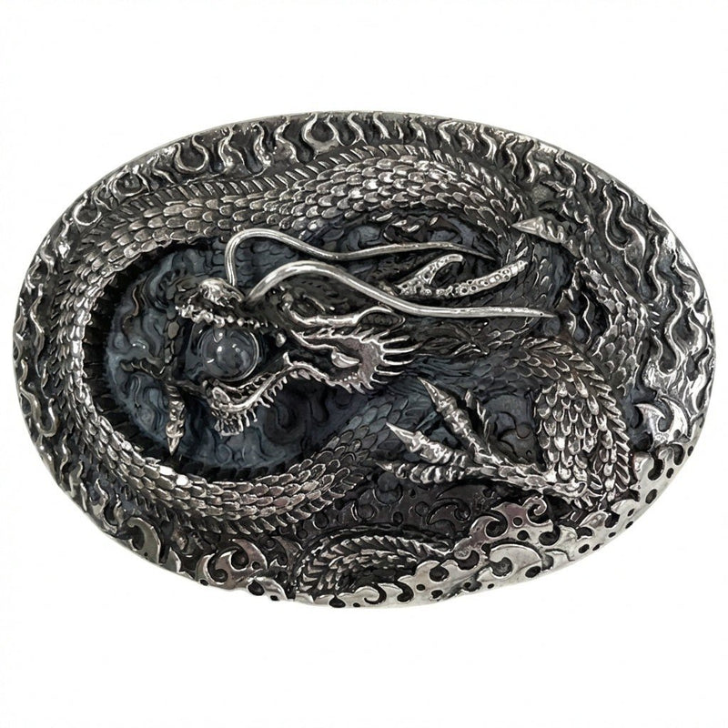 Front view of the sterling silver belt buckle featuring a hand-carved dragon clamping down on a crystal ball with a CZ eye.
