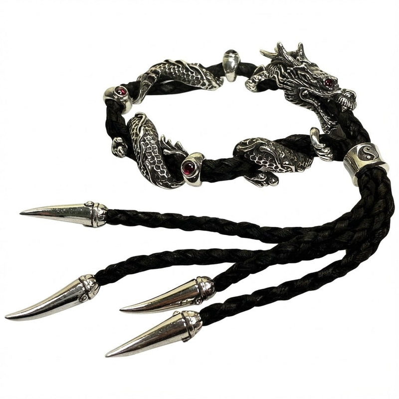 Sterling silver dragon bracelet with red garnet eyes on black braided leather featuring dragon claw endings