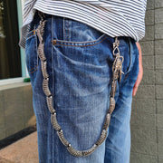 A side view of a model wearing the long and impressive dragon wallet chain, showing how it securely hangs from the belt loop.