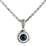 A solid sterling silver evil eye necklace pendant with a realistic blue eye and a beautifully detailed and ornate bail.