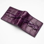 An opened view of the exotic purple crocodile wallet, showing the three-dimensional tail skin texture.