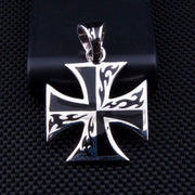 A sterling silver flame iron cross pendant featuring a bold black tattoo-style inlay design.