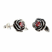 A pair of handcrafted garnet rose earrings in oxidized 925 sterling silver shown against a white background.