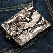 A genuine cobra skin wallet with a unique, natural snakeskin pattern and a custom sterling silver flame concho.