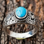Front view of the ring focusing on the vibrant blue genuine turquoise cabochon stone.