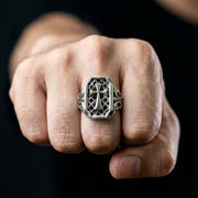 Gothic cross sterling silver men's ring worn on middle finger showing bold statement design