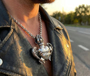 Man wearing Gothic flaming heart wings pendant in 925 sterling silver with leather jacket