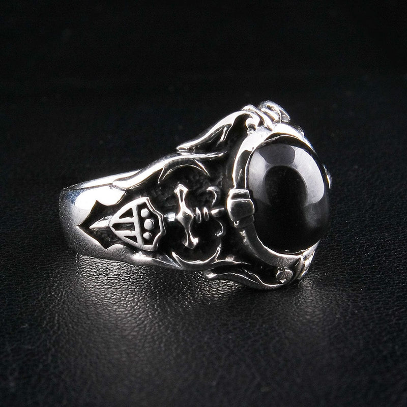 An angled view of the gothic black onyx signet ring, highlighting the detailed shield crest on the band.