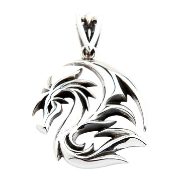 An angled view of the gothic tribal dragon pendant, highlighting its high-polish finish.