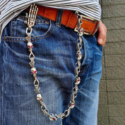 A massive, 300-gram solid sterling silver skull wallet chain with deep red ruby eyes and a unique skeleton hand clasp.