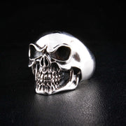 A heavy sterling silver laughing skull ring for men with a high-polish finish and oxidized details.