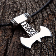 A heavy sterling silver Thor's Hammer pendant (Mjolnir) with intricate Celtic knot details, shown on a leather necklace.