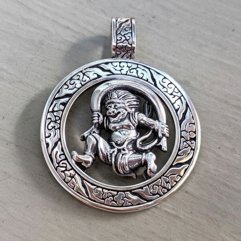 A front view of the sterling silver Japanese Fujin wind god pendant.