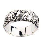 A sterling silver Japanese koi ring featuring two intricately engraved fish swimming in a continuous loop.
