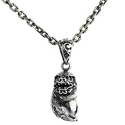 A handcrafted Japanese Komainu pendant in solid sterling silver, shown on a detailed silver chain.