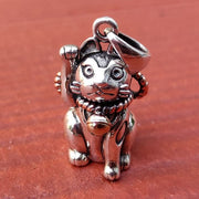 A handcrafted sterling silver Japanese Maneki-neko pendant, also known as a lucky cat charm for good fortune.