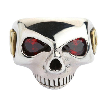 Front view of the solid sterling silver Johnny Depp skull ring showcasing deep red gemstone eyes and gold side details.