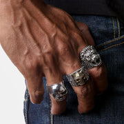 A model's hand wearing the large sterling silver lion head biker ring to demonstrate its impressive and substantial scale.