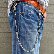 A man wearing a heavy sterling silver Maltese cross wallet chain attached to the belt loop of his blue jeans.