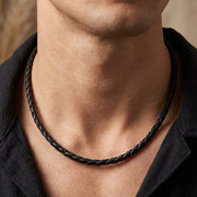 A close-up editorial photography of a man wearing a 4mm black leather necklace, 20 inches in length.