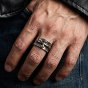 A man wearing the crusader cross ring on his finger, showing its 12mm width and two-tone design.
