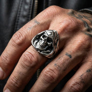 A man's fist wearing the heavy, large Grim Reaper skull ring, showcasing its impressive size.