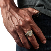 A men's two-tone ring with a sterling silver cannabis leaf on the face and gold-plated Rasta lions on the sides.