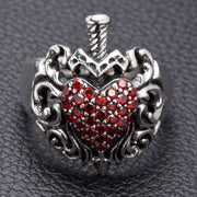 A men's gothic dagger heart ring, handcrafted from sterling silver and featuring a pavé of red garnet stones.