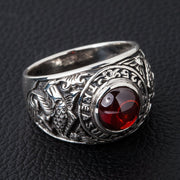 A men's solid sterling silver ring featuring a Japanese koi fish design on the shank and a large red cabochon stone.