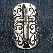 A men's solid sterling silver medieval armor ring, designed as a full-finger shield with a central dagger.