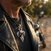 Man wearing 925 sterling silver skull dagger pendant necklace in biker style
