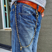A man wearing the long brass biker wallet chain attached to his jeans, showing its 23-inch length and drape.