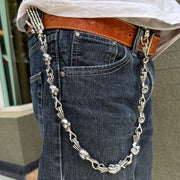A man wearing the diamond skull wallet chain attached from his belt loop to his leather wallet, showcasing the biker style.