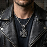 Men wearing sterling silver iron cross pendant with chain over black shirt and leather jacket