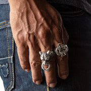 A man's hand wearing the large sterling silver number 13 ace of spades ring.