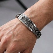 Heavy sterling silver dragon ID bracelet worn on a male wrist