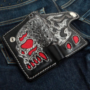 Open view of handcrafted leather biker wallet showing flaming skull design and red stingray inlays