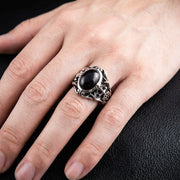 Man wearing a sterling silver Onyx Knight Signet Ring featuring a black stone and medieval shield design